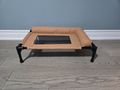 Front view of the Breeze Cot showing raised height and non-slip rubber feet