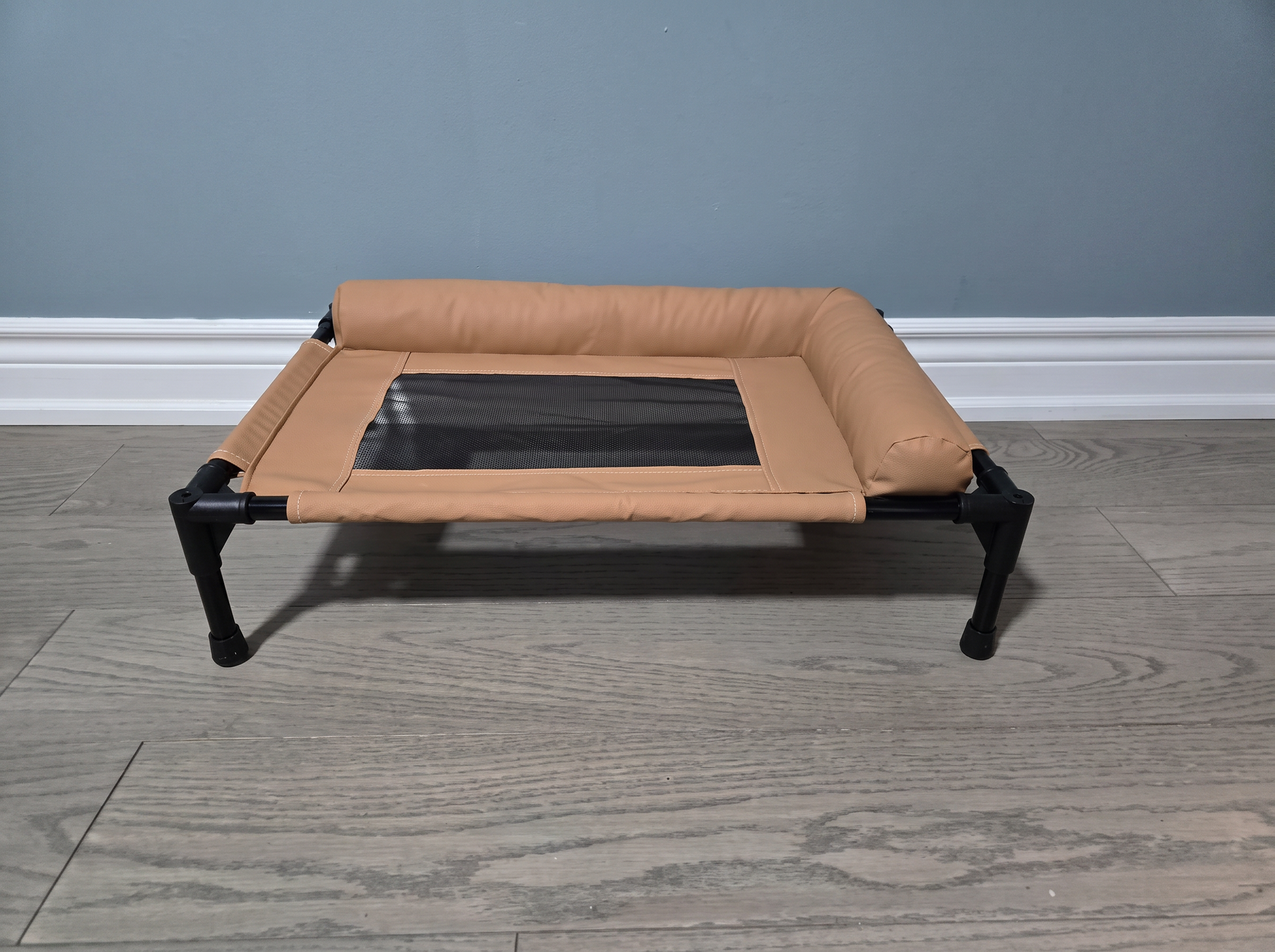 Front view of the Breeze Cot showing raised height and non-slip rubber feet