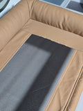 Top-down detail of the breathable mesh sleeping surface with contrast stitching