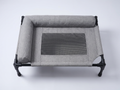 Top view of the grey Breeze Cot — L-shaped bolster and mesh centre