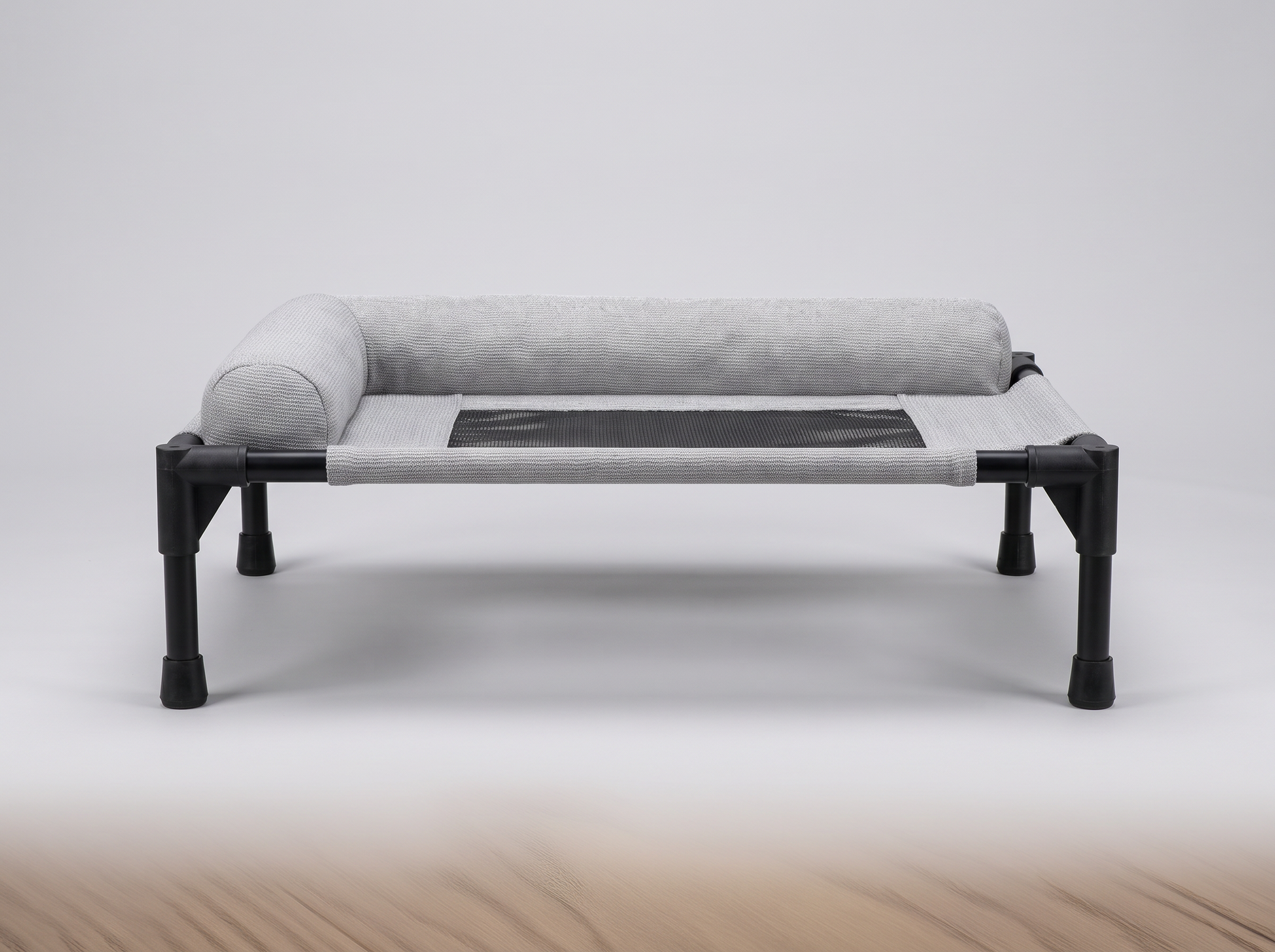 Front view of the grey Breeze Cot showing raised height